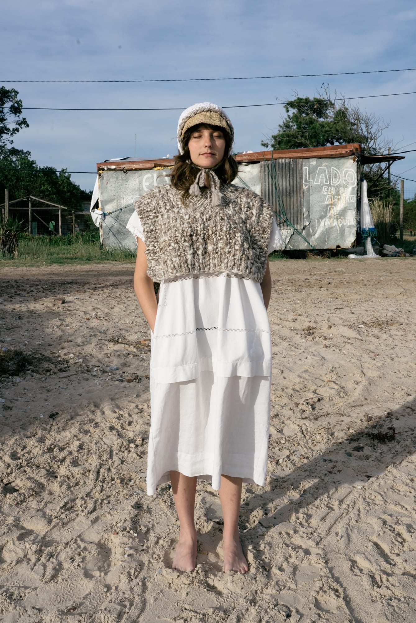 Model wearing Vest Higo in soft stone grey — relaxed slow-fashion styling.