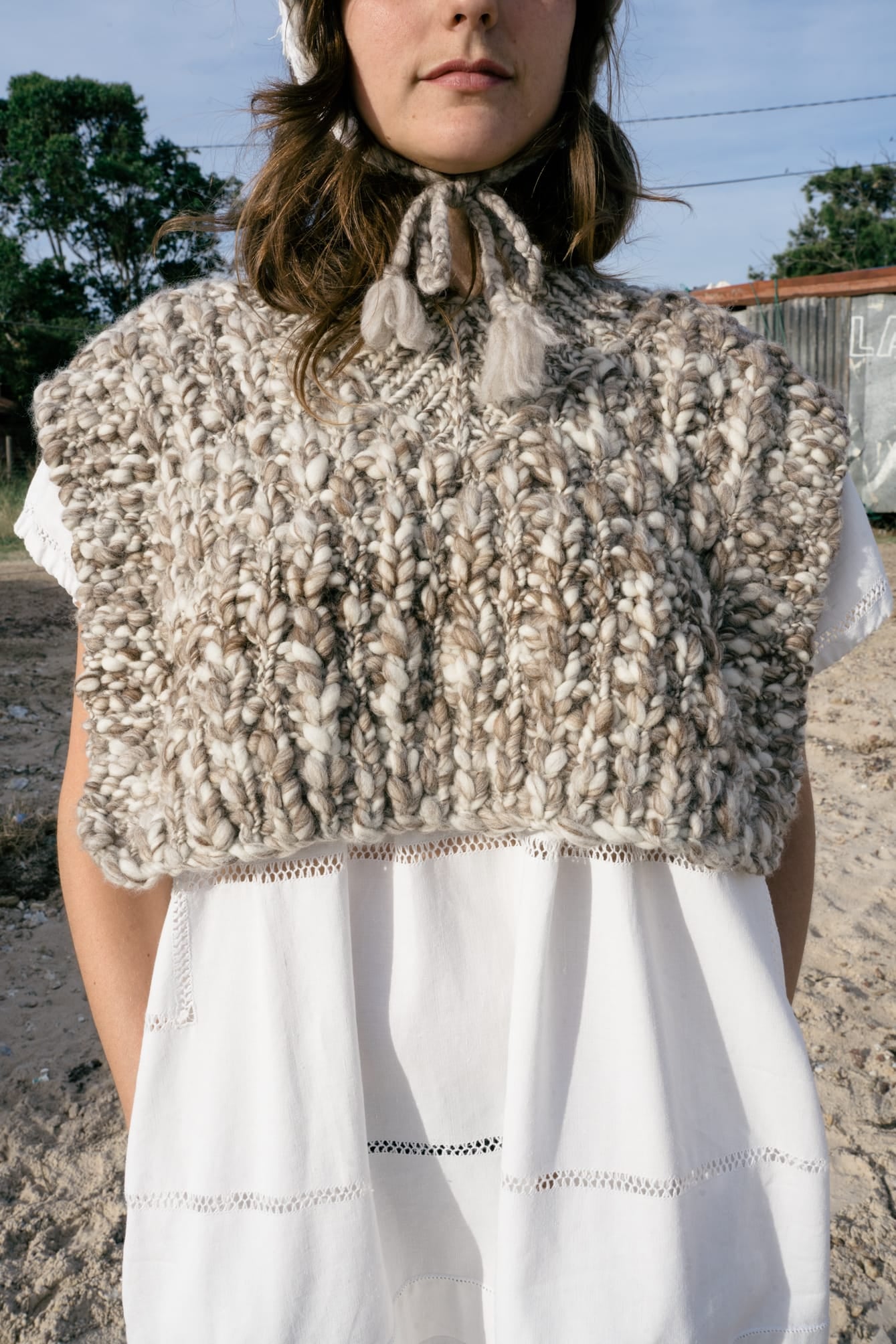 Vest Higo in soft stone grey — hand-knitted merino wool, alternate view.