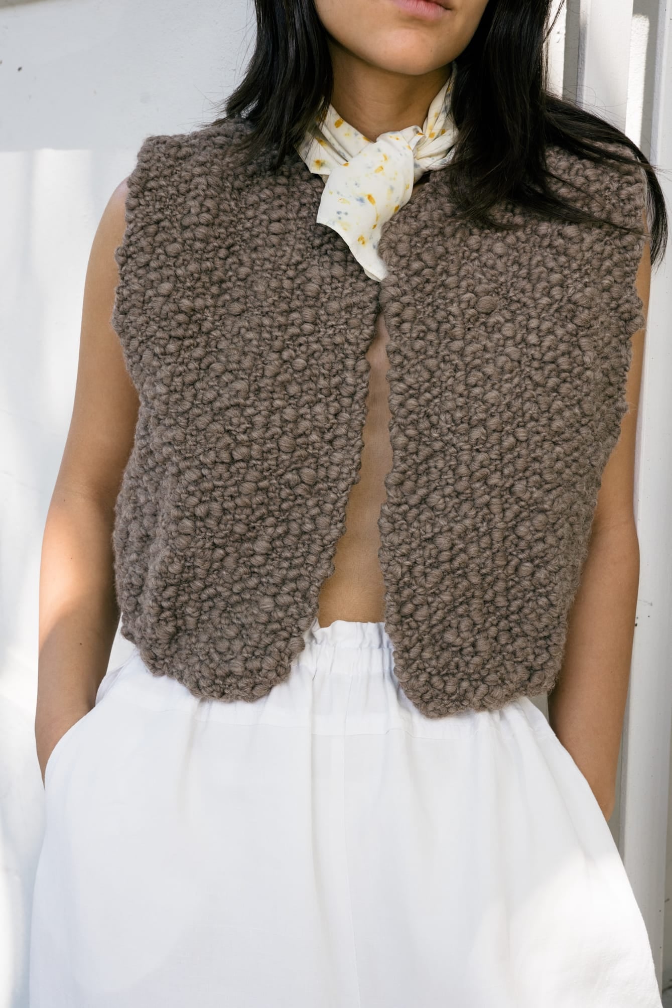 Fumo Vest full view — hand-knitted merino wool, styled on figure.
