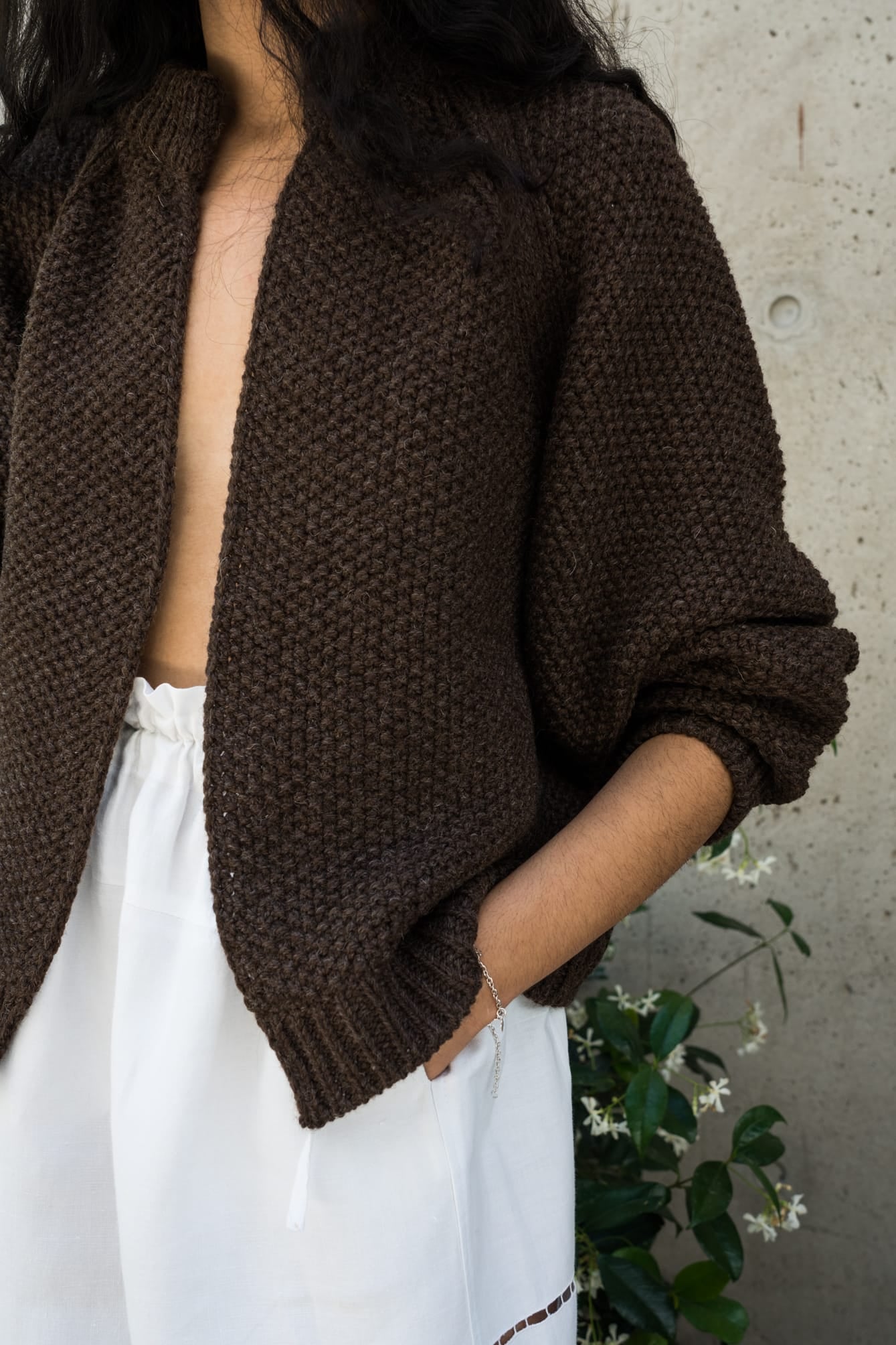 Bravo Cardigan full view — hand-knitted wool, styled on figure.