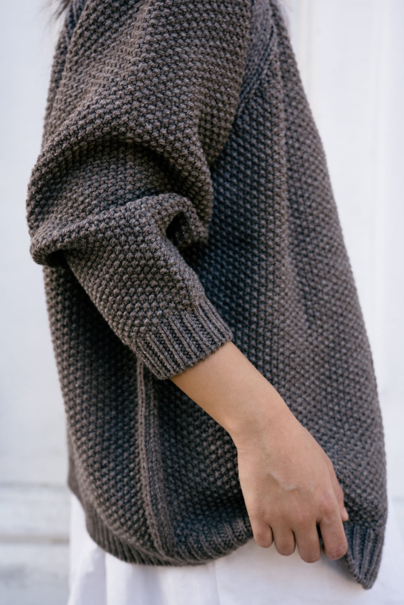 Model wearing Lapacho Cardigan in warm brown — relaxed slow-fashion styling.