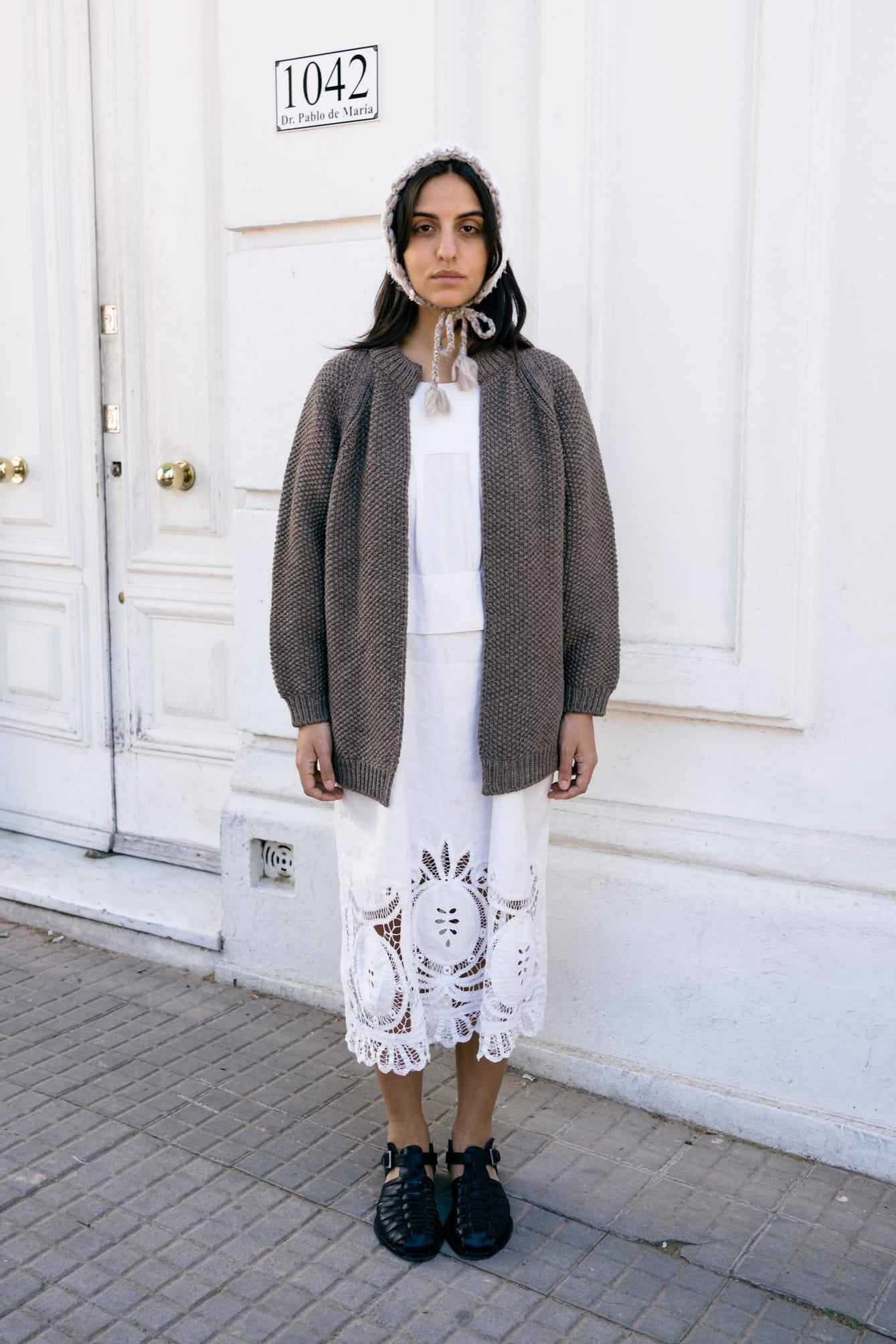 Lapacho Cardigan full view — hand-knitted merino wool, styled on figure.
