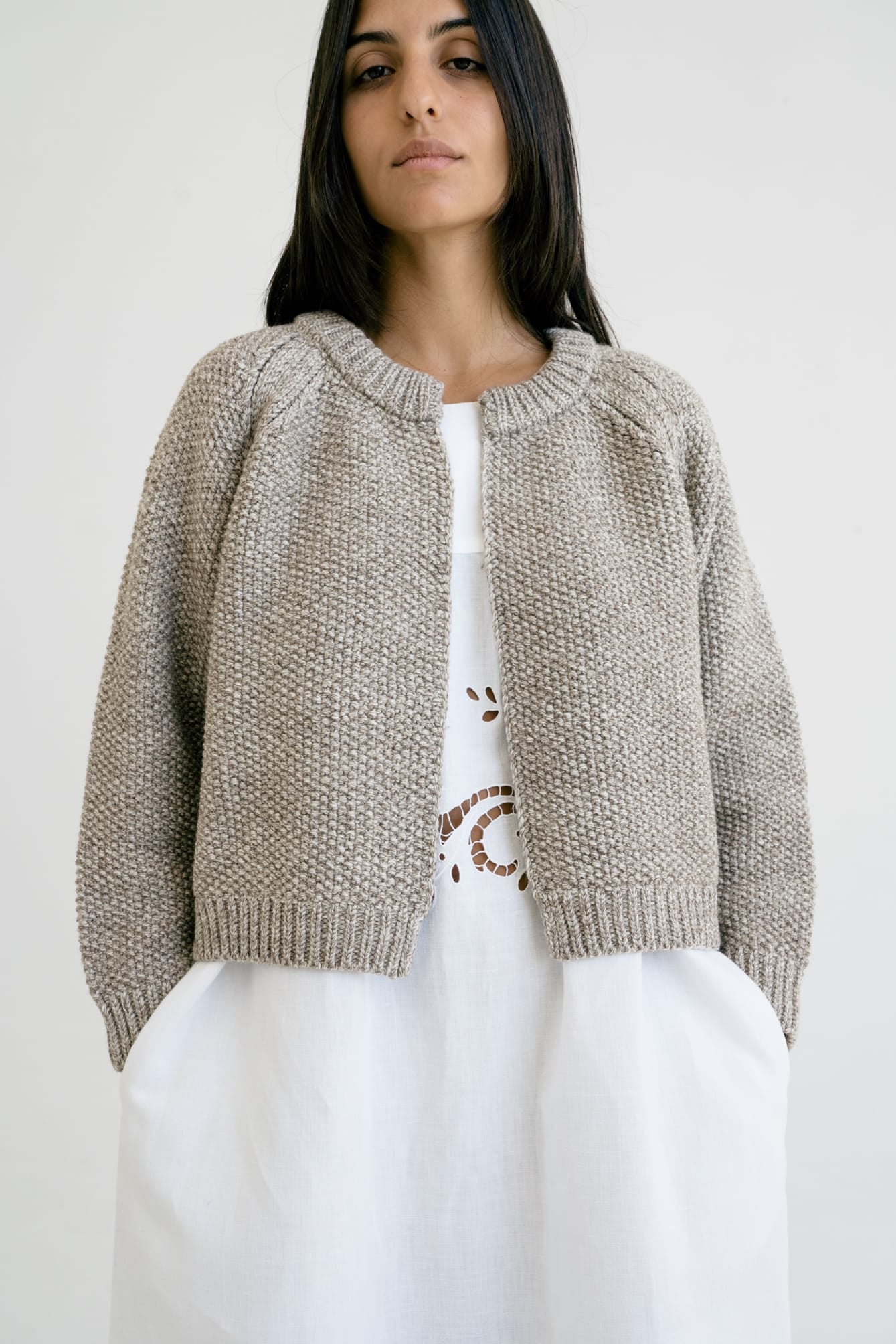 Bravo Cardigan full view — hand-knitted merino wool, styled on figure.
