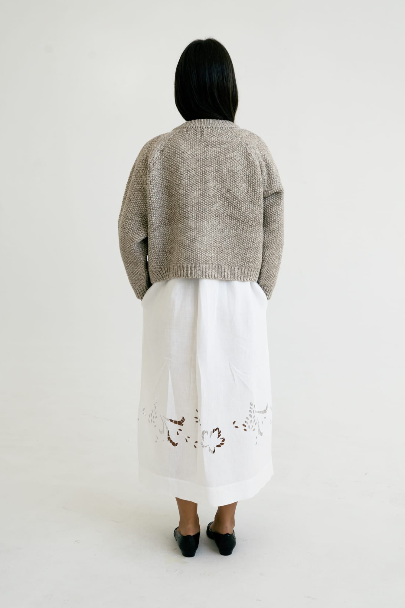 Model wearing Bravo Cardigan in soft stone grey — relaxed slow-fashion styling.