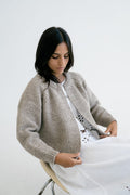 Bravo Cardigan in soft stone grey — hand-knitted merino wool.