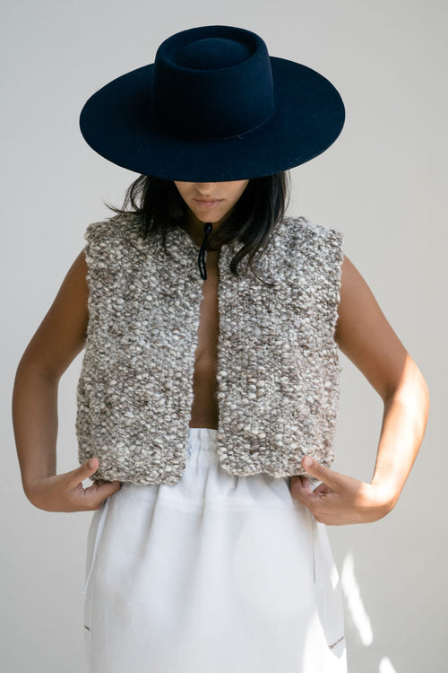 Fumo Vest in soft stone grey — hand-knitted merino wool.