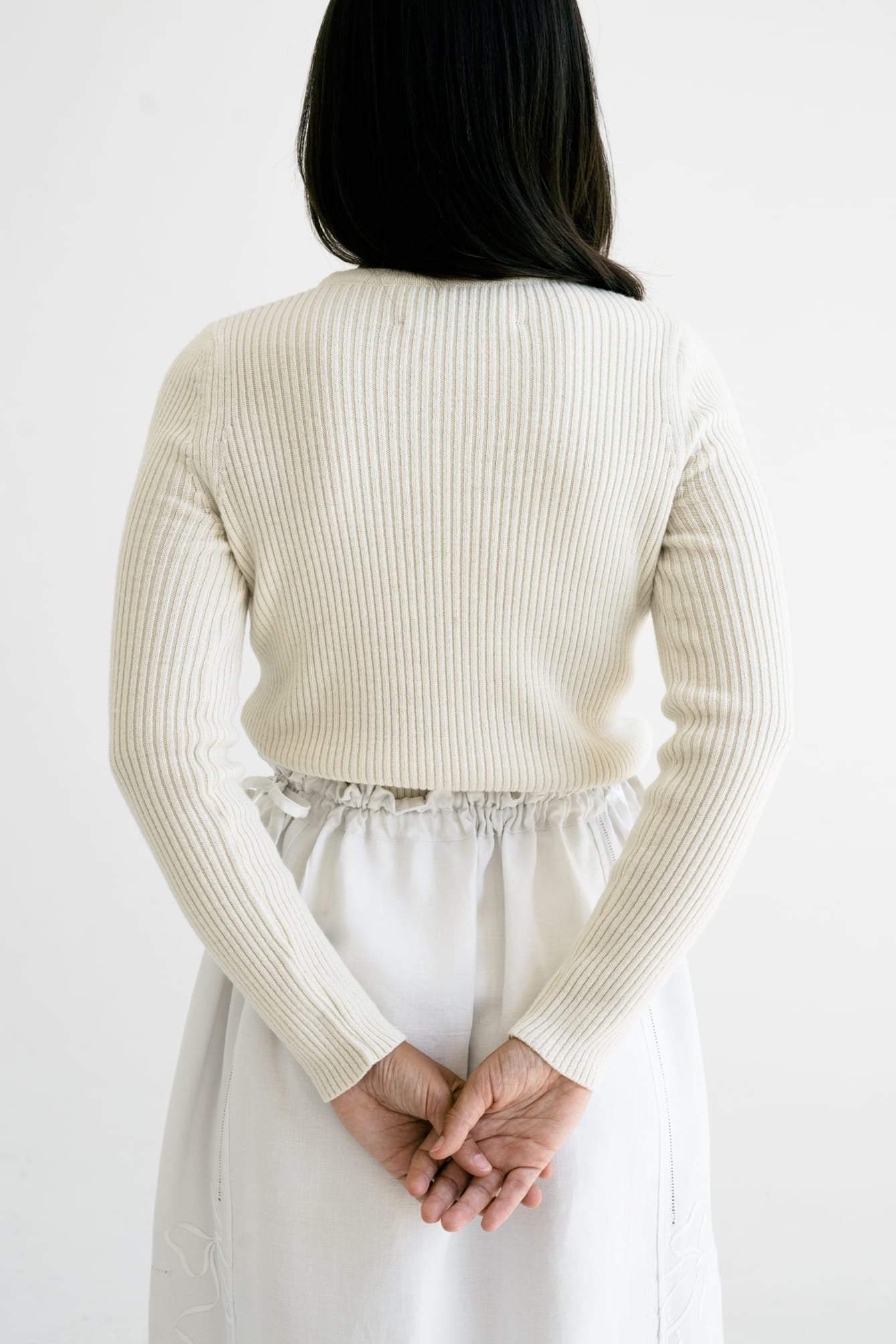 Truco Crew Neck full view — hand-knitted merino wool, styled on figure.