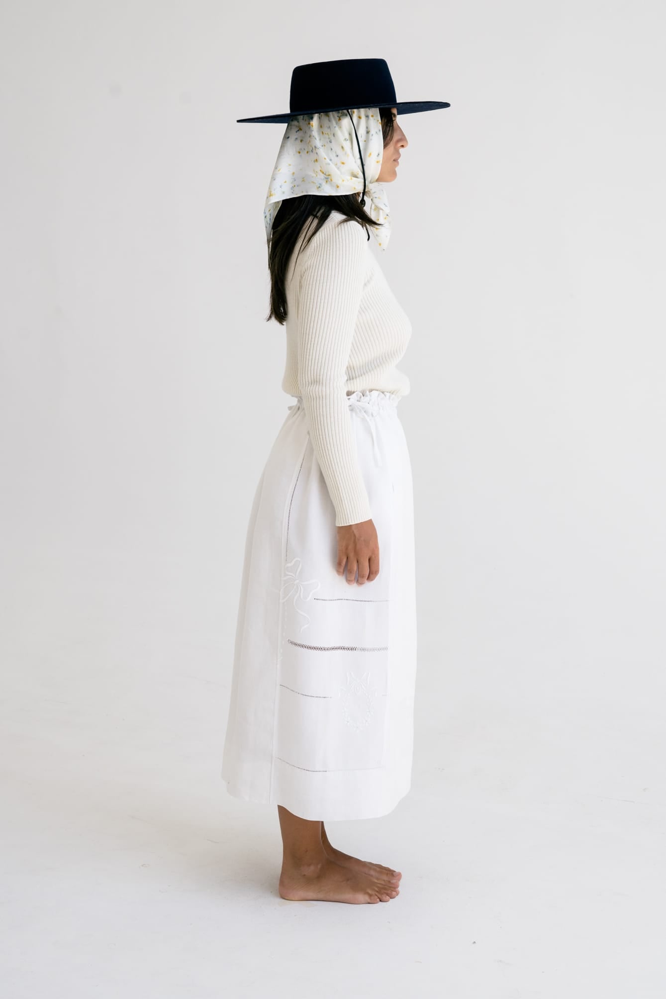 Model wearing Truco Crew Neck in soft ivory — relaxed slow-fashion styling.