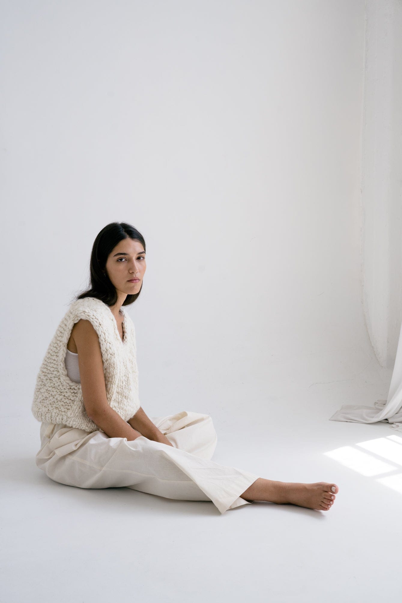 Acacia Vest in soft ivory — hand-knitted merino wool.