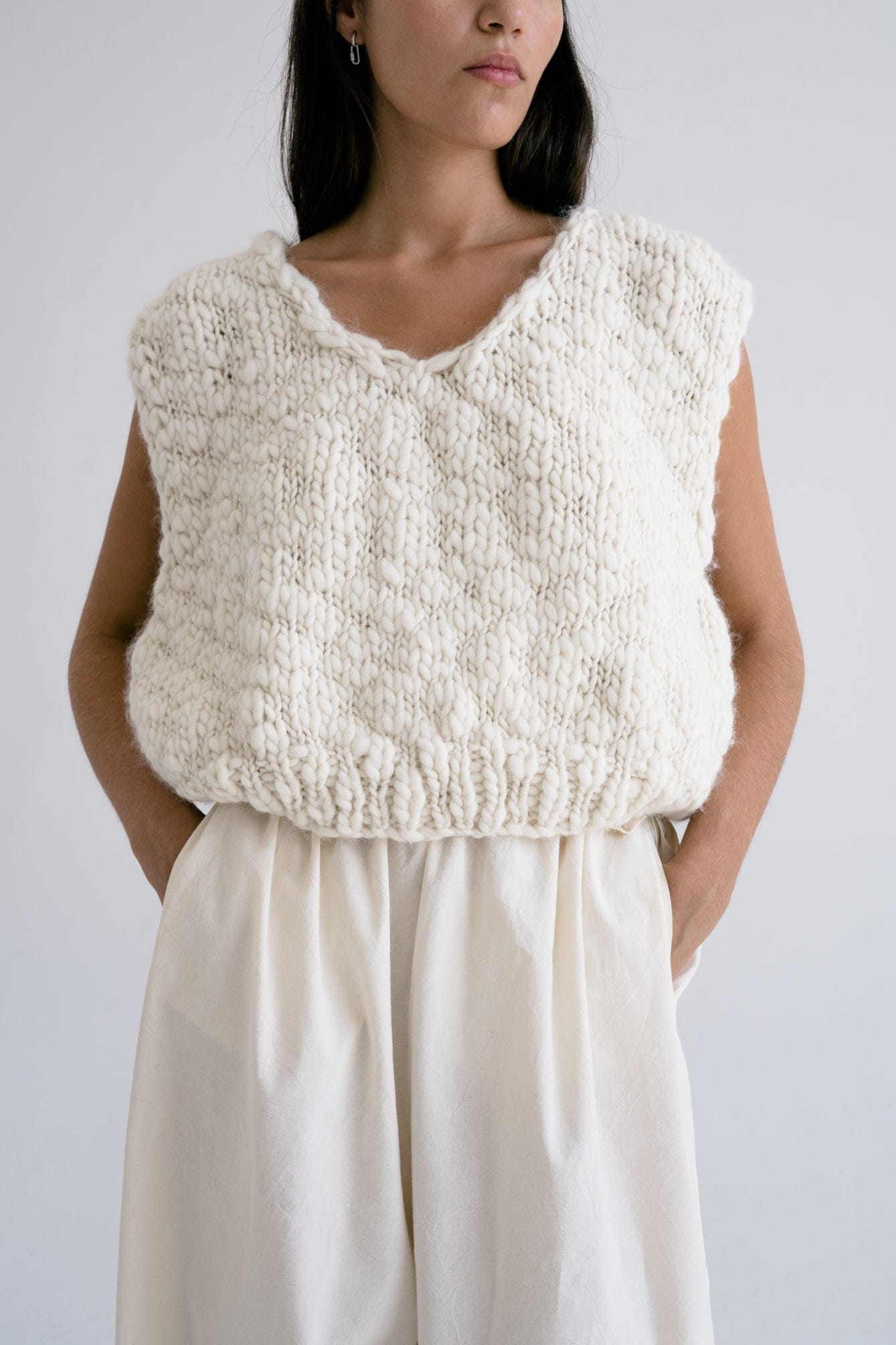 Model wearing Acacia Vest in soft ivory — relaxed slow-fashion styling.
