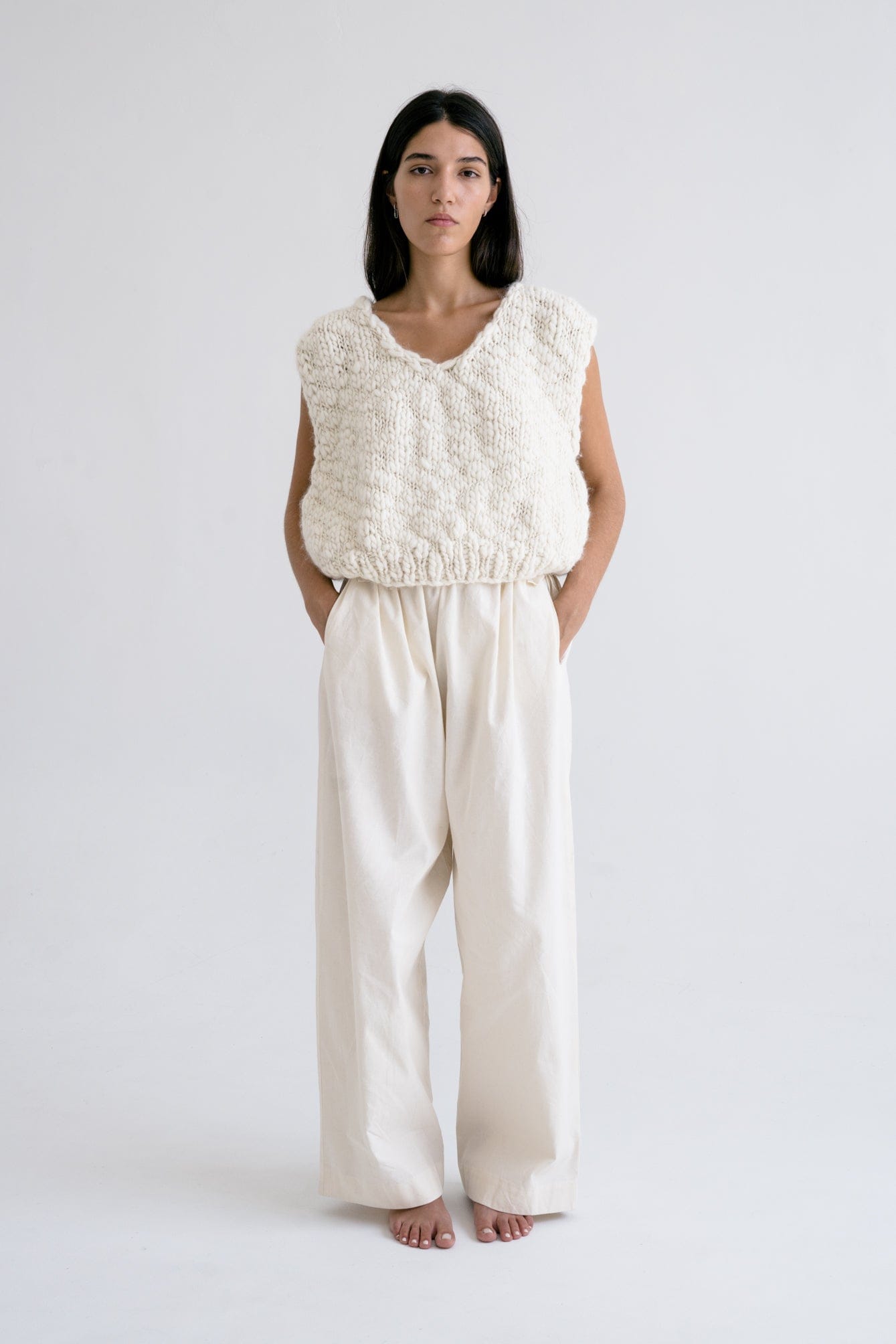Acacia Vest full view — hand-knitted merino wool, styled on figure.