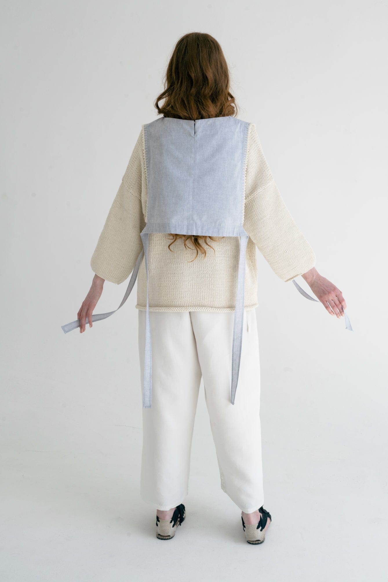 Model wearing Aromita Slipover Top in sky blue — relaxed slow-fashion styling.