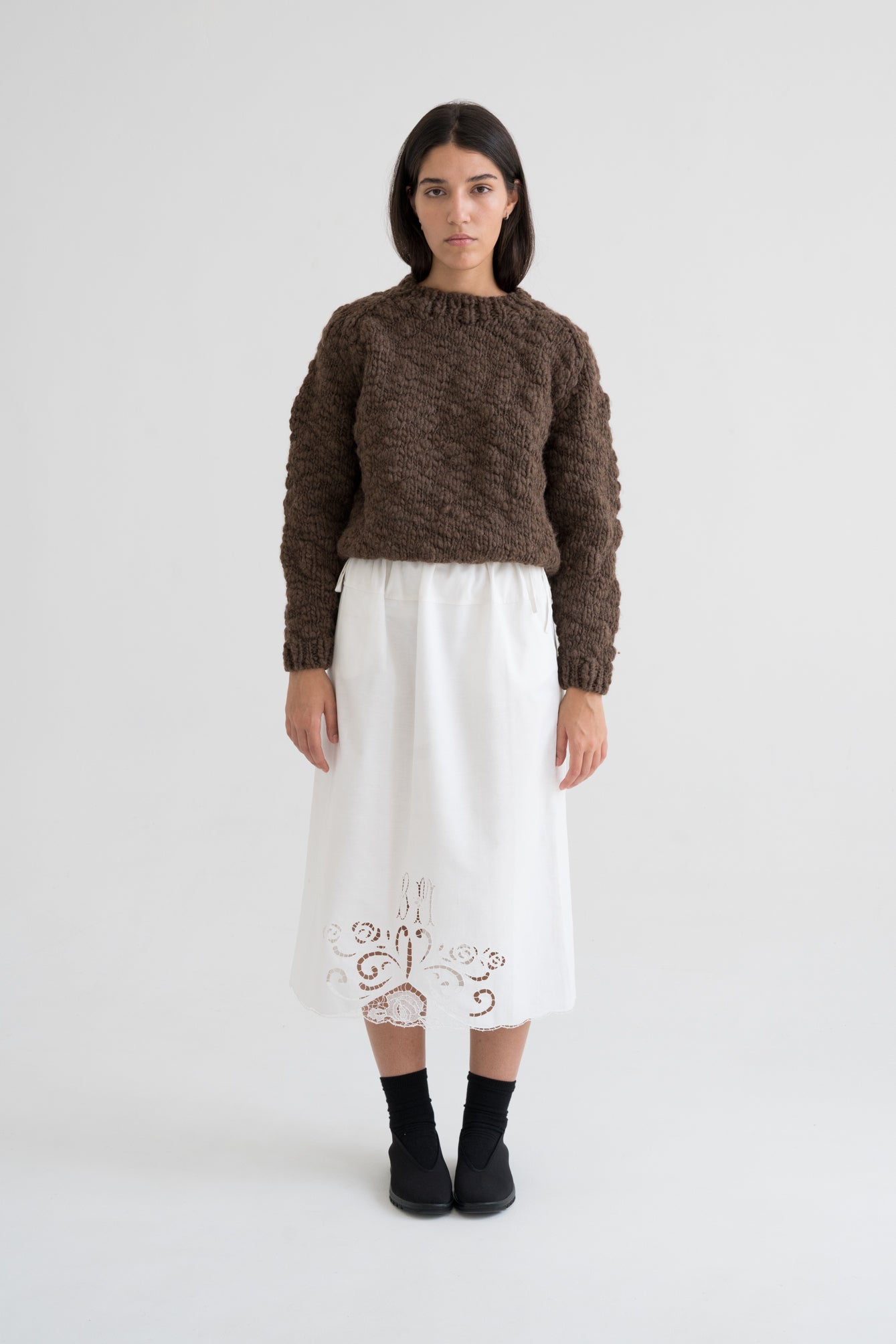 Caven Jumper full view — hand-knitted wool, styled on figure.