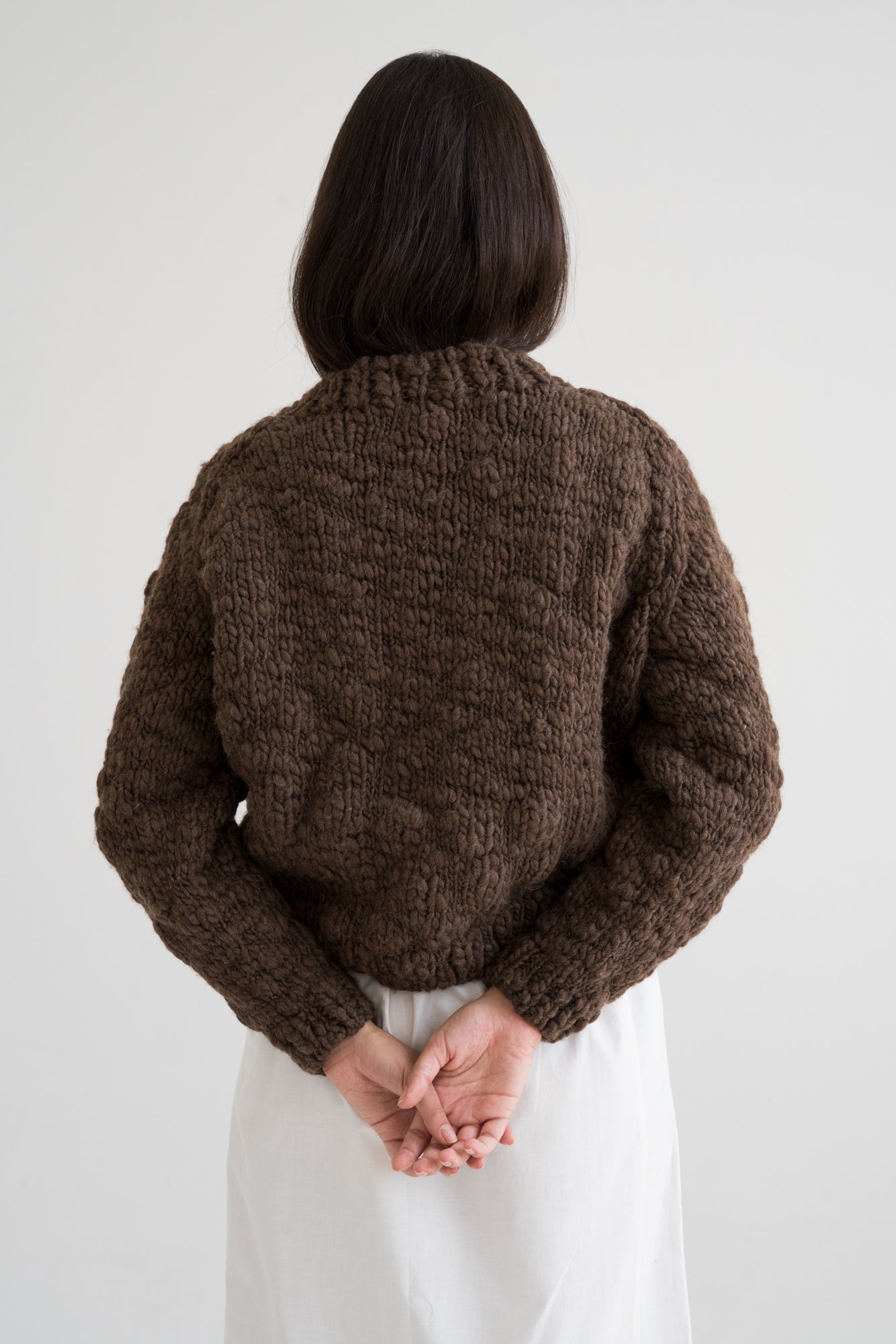 Caven Jumper in earth brown — hand-knitted wool, alternate view.