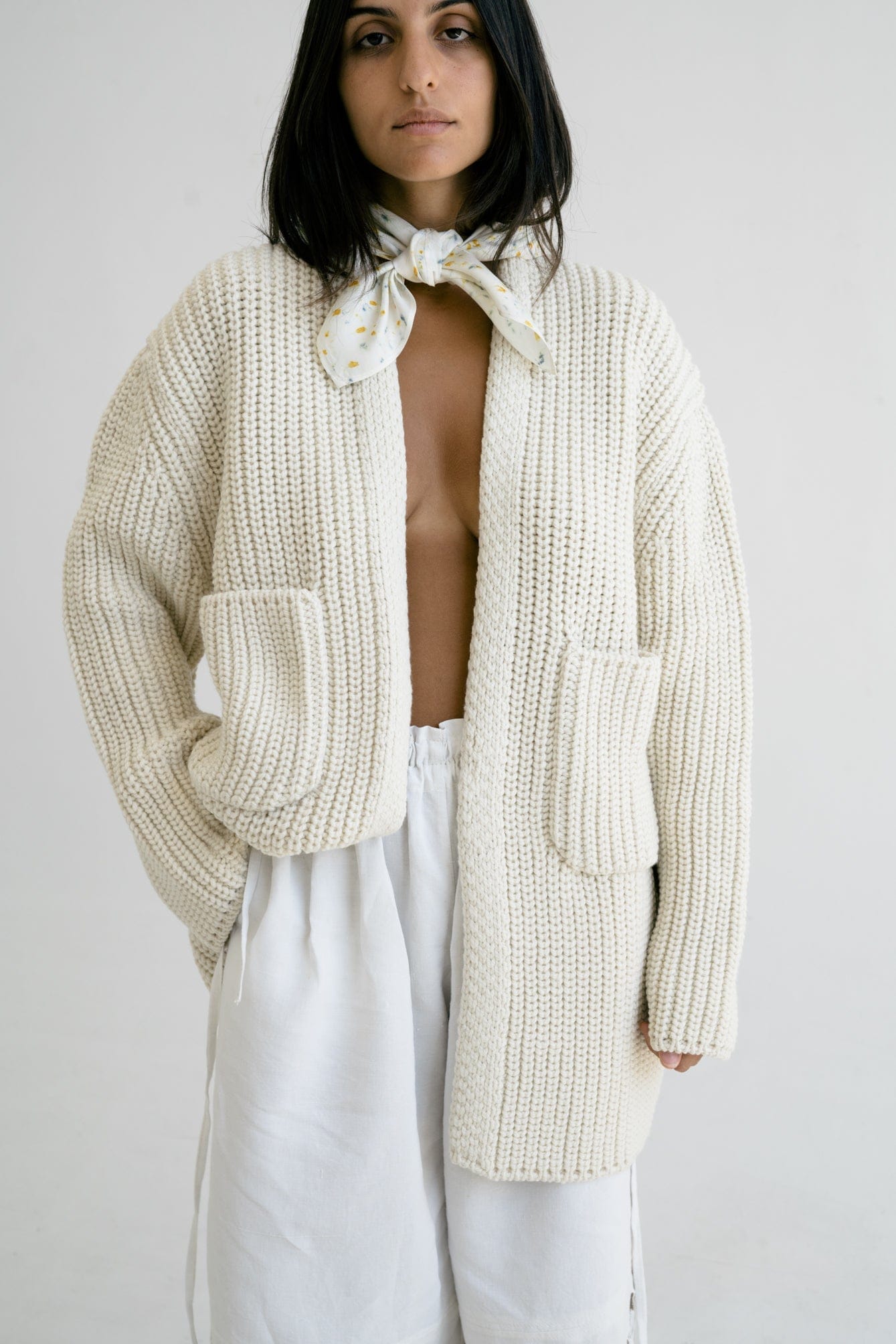 Model wearing Cedro Cardigan in soft ivory — relaxed slow-fashion styling.