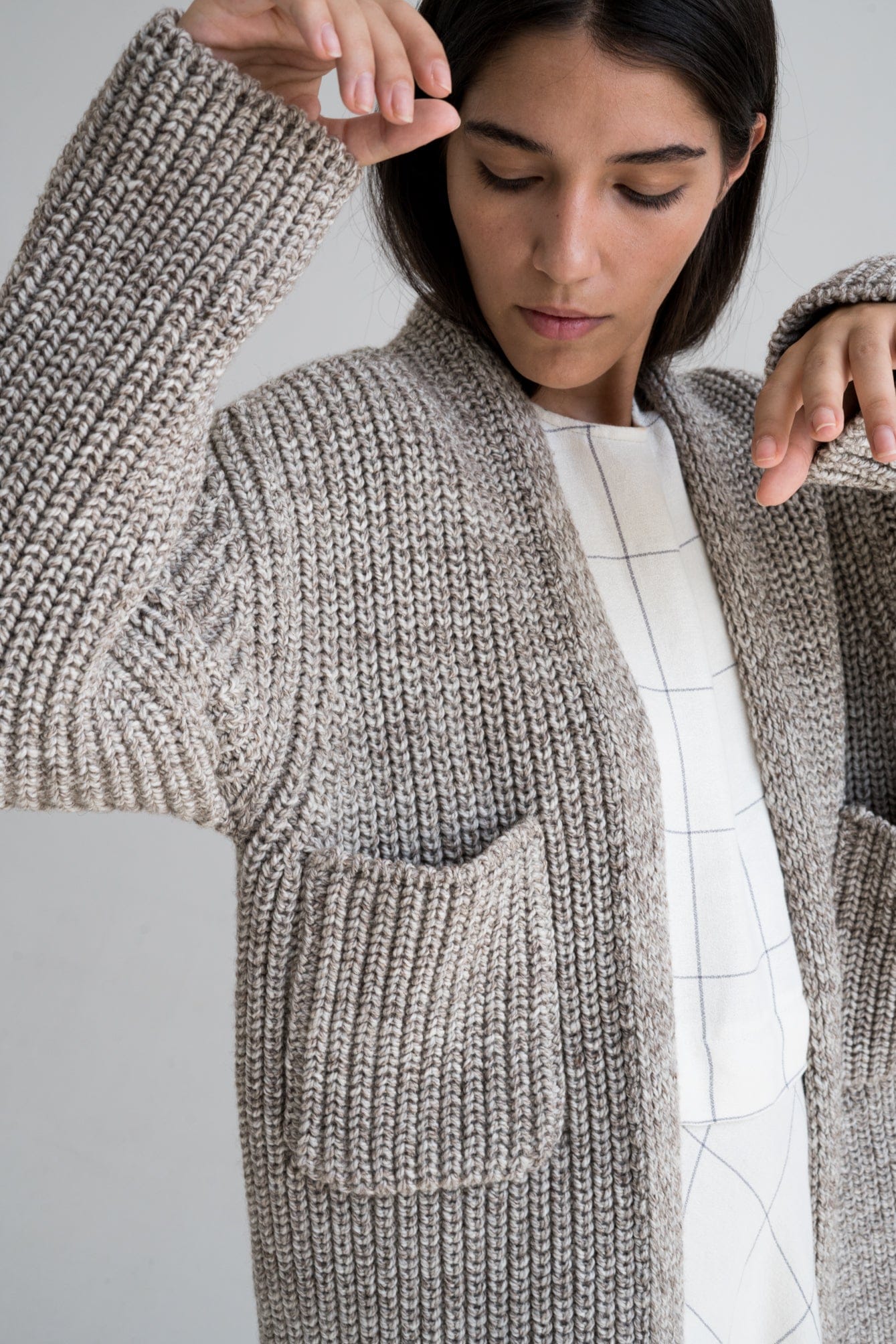 Cedro Cardigan in soft stone grey — hand-knitted merino wool.