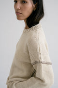 Crudo Jumper in natural undyed tone — hand-knitted merino wool.