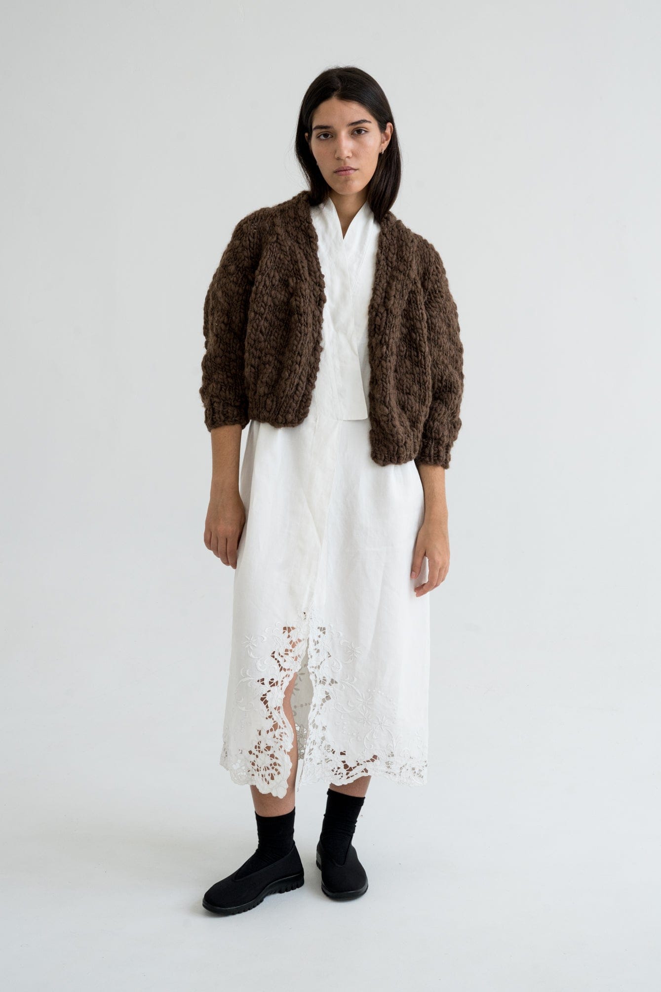 Jacaranda Cardigan full view — hand-knitted wool, styled on figure.