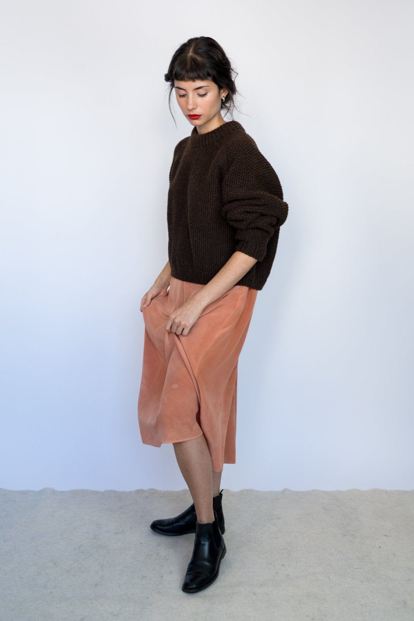 Naca Jumper full view — hand-knitted wool, styled on figure.