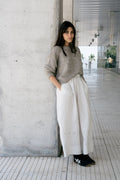 Naca Jumper in soft stone grey — hand-knitted merino wool.