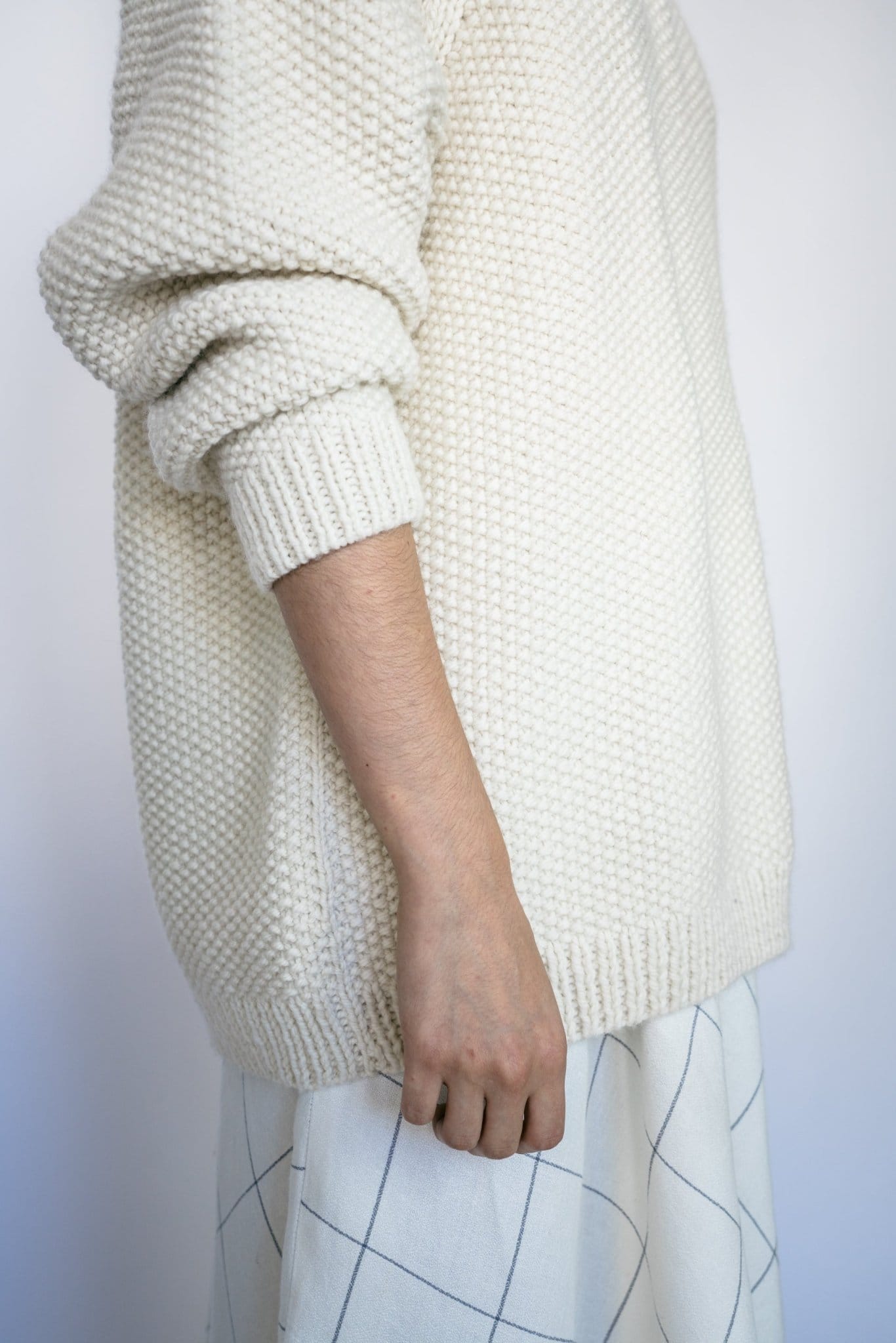 Model wearing Roble Jumper in soft ivory — relaxed slow-fashion styling.