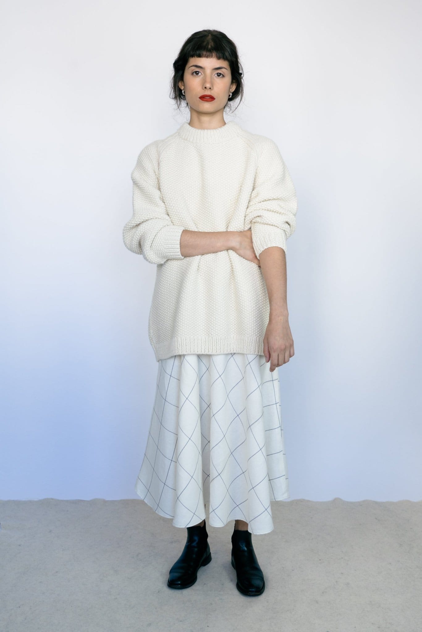 Roble Jumper full view — hand-knitted merino wool, styled on figure.