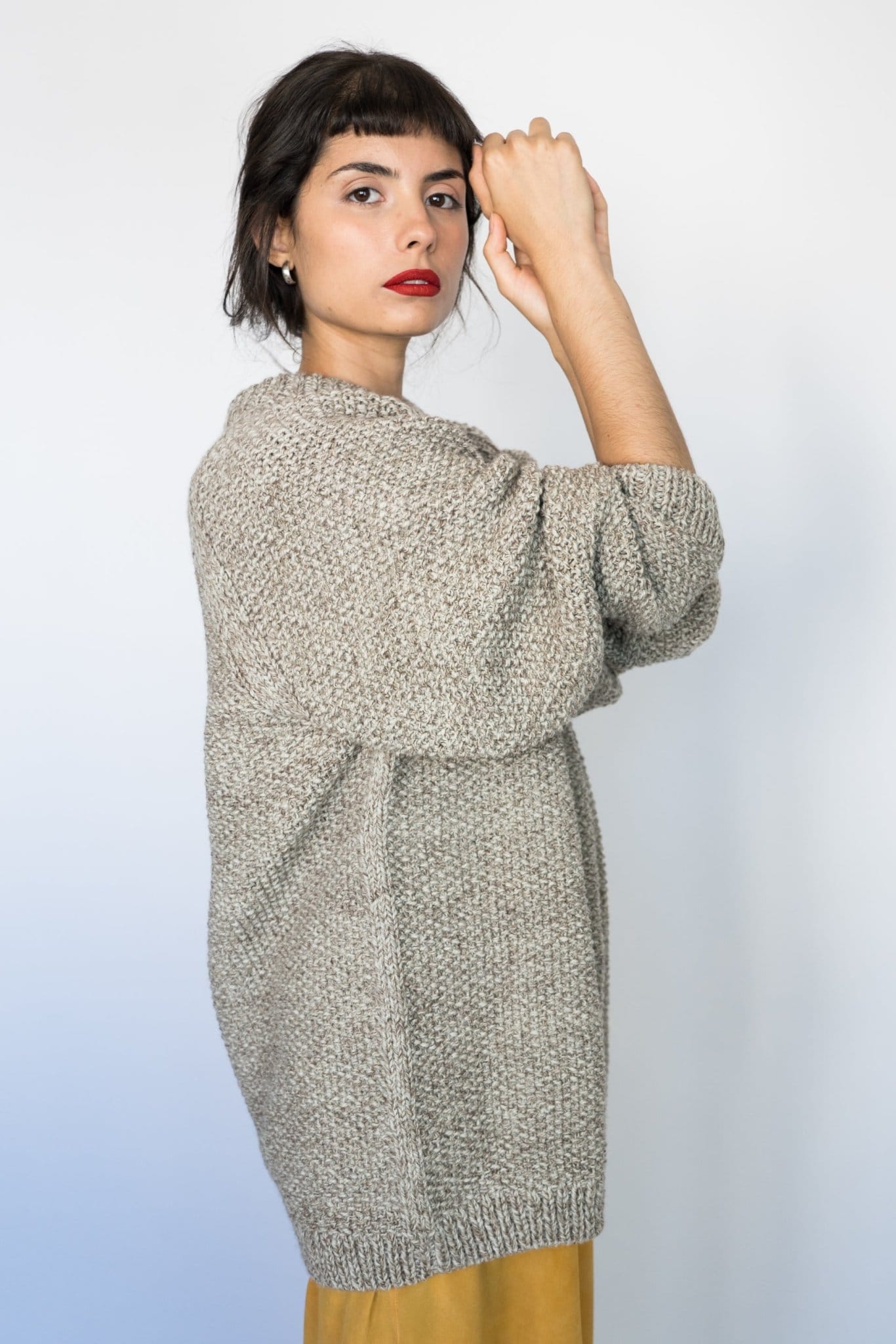 Model wearing Roble Jumper in soft stone grey — relaxed slow-fashion styling.