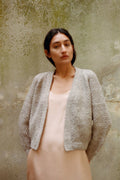 Sauco Cardigan in soft stone grey — hand-knitted merino wool.