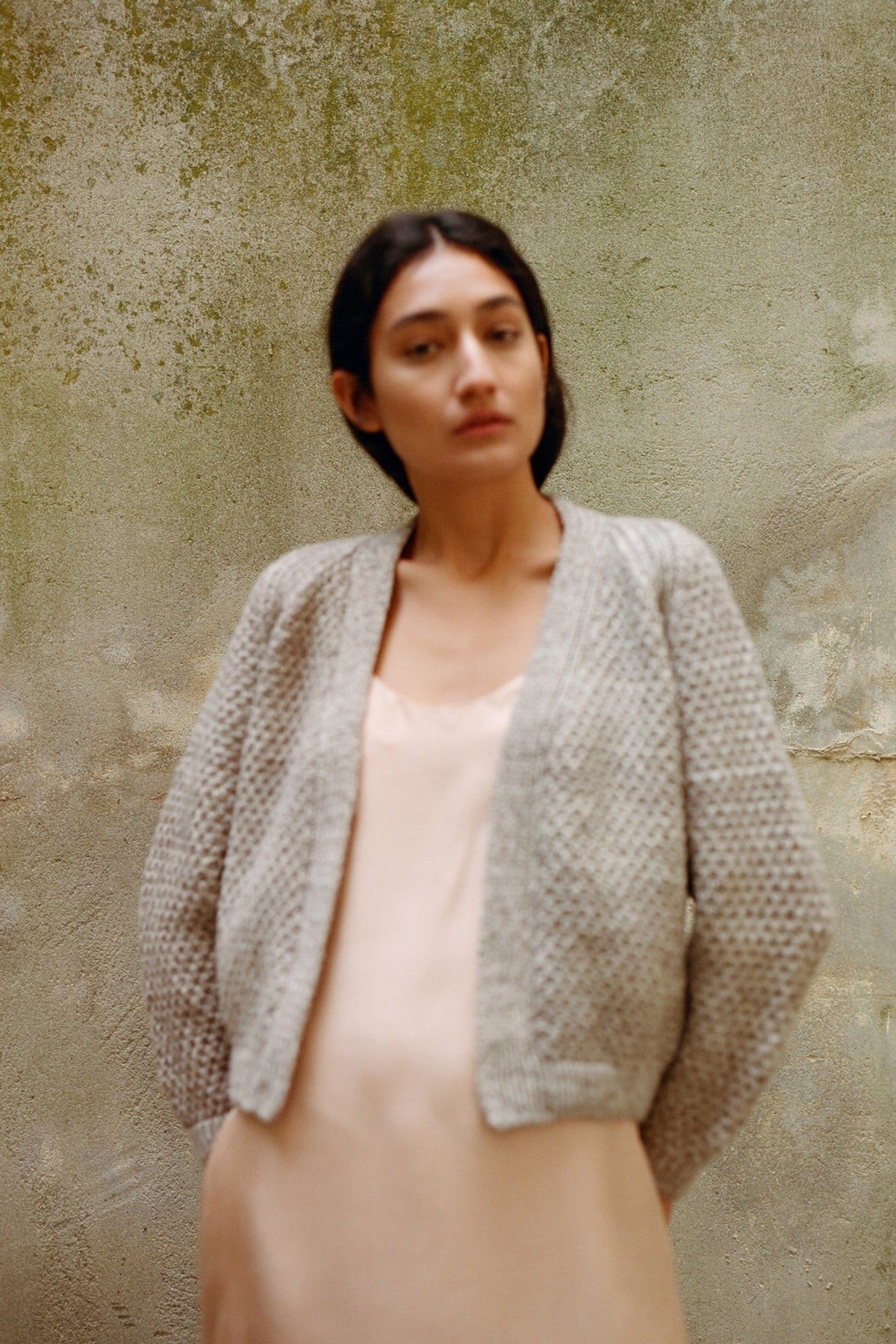 Sauco Cardigan in soft stone grey — hand-knitted merino wool.