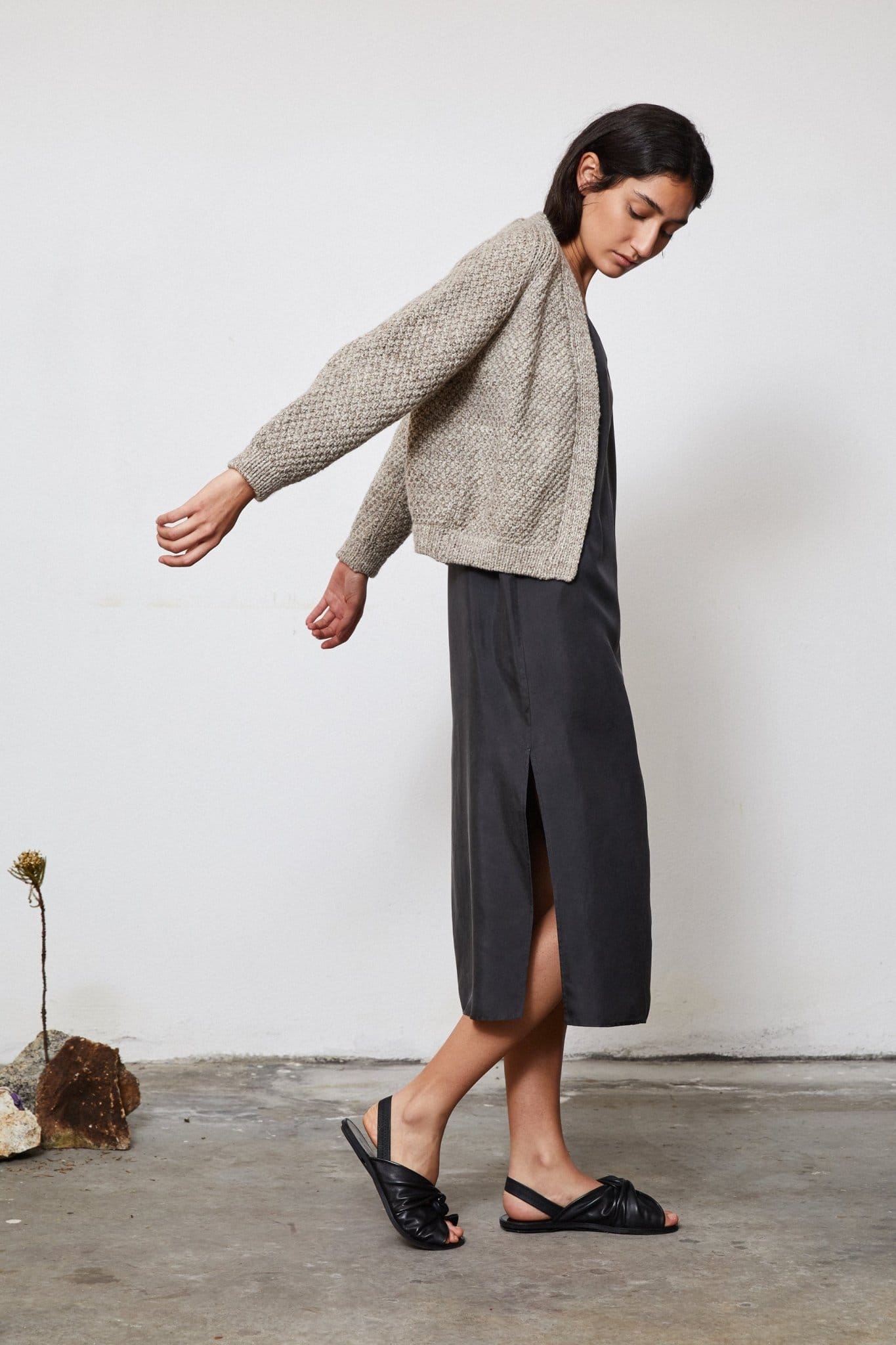 Model wearing Sauco Cardigan in soft stone grey — relaxed slow-fashion styling.
