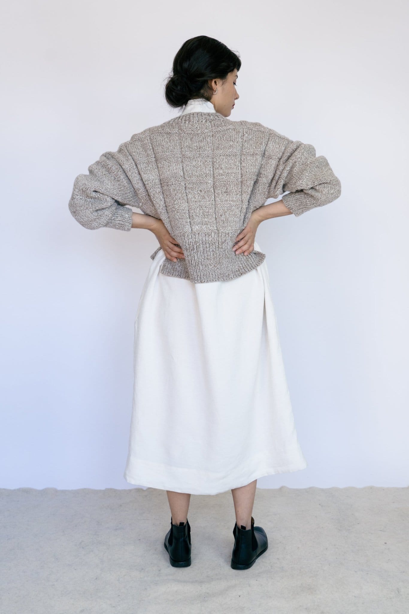 Tala Jumper in soft stone grey — hand-knitted merino wool, alternate view.