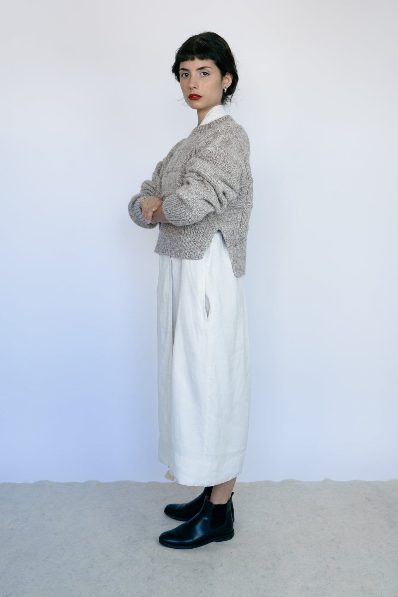 Model wearing Tala Jumper in soft stone grey — relaxed slow-fashion styling.