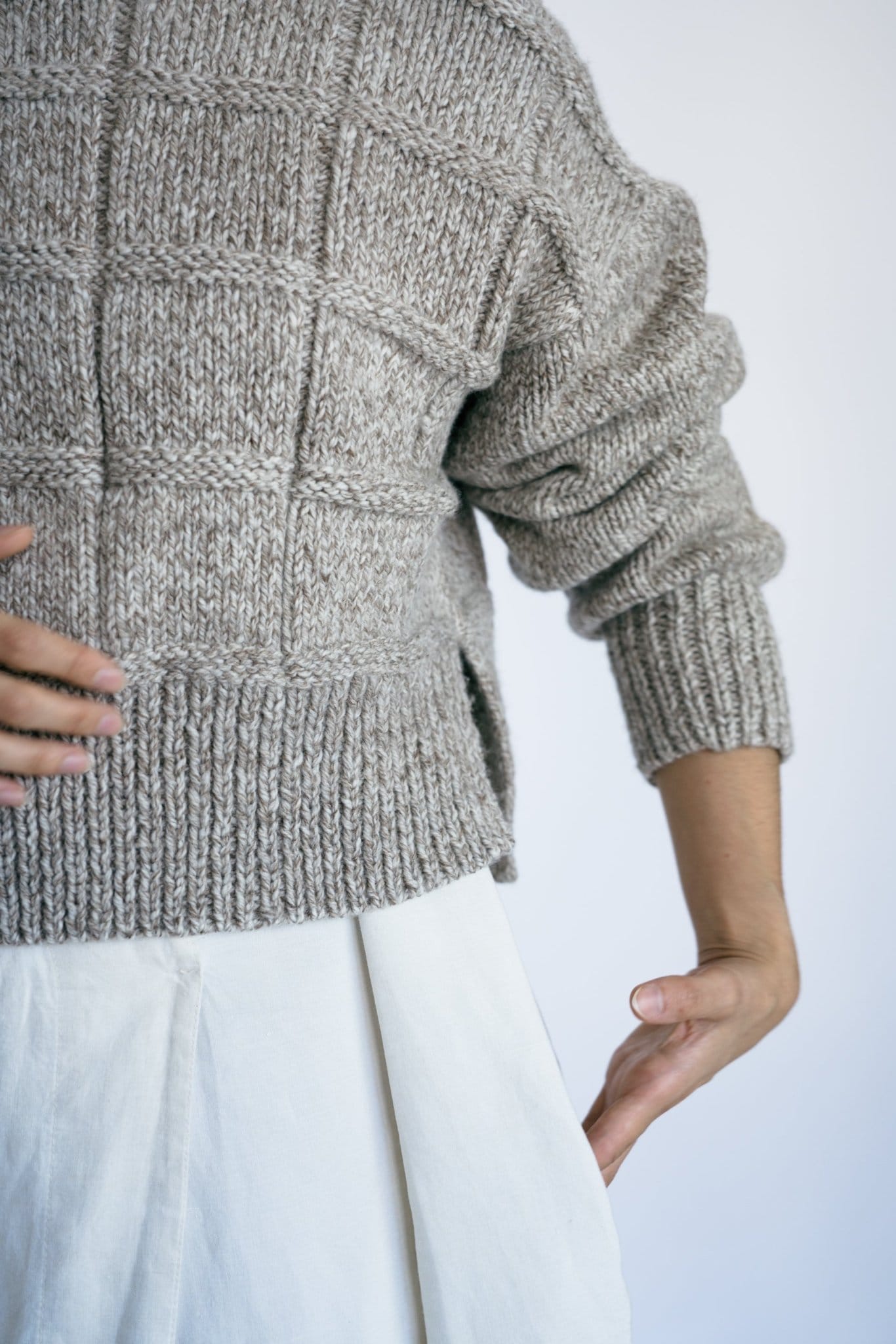 Tala Jumper in soft stone grey — hand-knitted merino wool, alternate view.